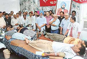 Employees donate blood at a camp organised on the 107th death anniversary of Sardar Dyal Singh Majithia, founder of The Tribune, organised by The Tribune Employees Union in Chandigarh on Friday. 