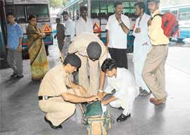 The police searches a passenger's luggage at the Sector 17 bus terminus in Chandigarh on Friday.