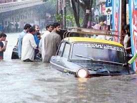 Cabs inundated in water at Mahim in Mumbai after heavy rain on Friday