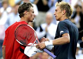 Lleyton Hewitt of Australia consoles Jarkko Nieminen of Finland after their quarterfinal at the US Open in New York
