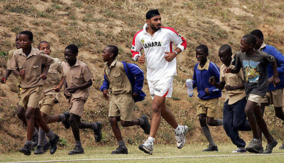 Indian off-spinner Harbhajan Singh warms up with local boys before the second days play of Indias match against Zimbabwe Board XI in Mutare on Friday