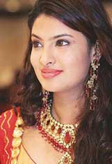 Sayaliu Bhagat, Miss India World 2004, wears a jewellery set at an exhibition in Bangkok on Saturday. 