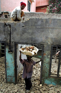 Labourers at a Dalit victims house in Gohana, where the PWD has started the rehabilitation work