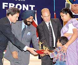 British High Commissioner to India Michael Arthur (left), Mr M. S. Bitta, Chairman, AIATF (second from left), United States Ambassador to India Howard J. Madnick (second from right) fecilitating Maskura Bibi (right) widow of one of the martyrs of the attack on the American Center, on World Terrorism Day in New Delhi on Saturday.