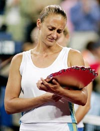 Mary Pierce of France looks at her trophy following her loss to Kim Clijsters of Belgium in the women's final at the US Open in New York 