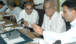 Haryana Chief Minister Bhupinder Singh Hooda discusses a point with Randeep Singh Surjewala and Venod Sharma at a meeting of the CLP at Haryana Vidhan Sabha in Chandigarh on Monday.