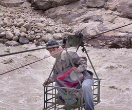 A man crosses the Sutlej on a cable trolley at Kharo village in Kinnaur district.