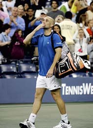 Andre Agassi of the US blows a kiss to the crowd following his loss to Roger Federer 