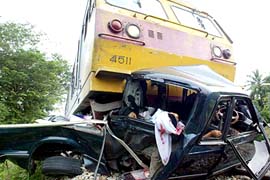 A pick-up truck, which was taking children home from school, is seen with dead passengers after it crashed with a train in Yala province, about 1,200 km south of Bangkok, on Monday