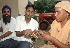 Rajvir shows to his mother and father the things that he had made in jail at Dhoomcheeri village in Morinda district