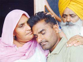 Joginder Kaur, mother of Lakhwinder Singh, hugs her son who reached home after being released from a Pakistani jail at her residence in Ajrawar village