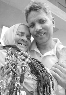 Suraj Bhan hugs his mother after reaching his home at Rajouli village in Ambala