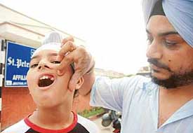 Mr Manjeet Singh shows his sons missing tooth outside St. Peters School, Sector 37, Chandigarh, on Wednesday