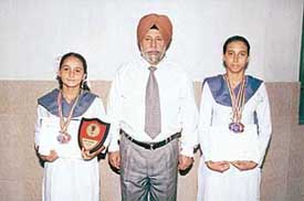Harsimran Kaur  and Shruti Sharma with Mr D.S. Bedi, Director-Principal of Shivalik Public School, in Chandigarh on Wednesday