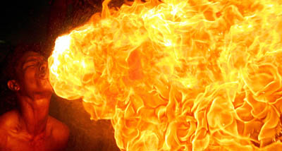 A fireeater performs during the Queen's Baton relay run in New Delhi on Wednesday