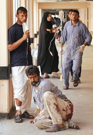 Wounded Iraqi labourers are treated in hospital after a suicide car bomb attack in Baghdad on Wednesday