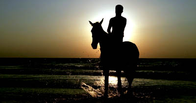 A Palestinian man rides his horse at sunset on a Gaza beach on Wednesday