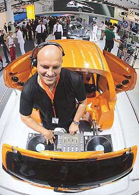 DJ Oliver uses turn-tables built into Japanese car manufacturer Toyota's DJ-AYGO show car during the first public day at the 61st International Car Show in Frankfurt on Thursday