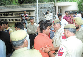 Police personnel trying to calm down students demonstrating at IIT Delhi against the new eligibility norms for IIT entrance examination