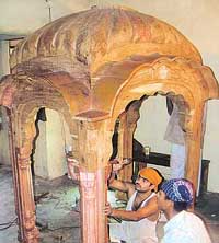 Craftsmen work on the gold palanquin, which will be installed at Nankana Sahib Gurdwara in Pakistan.