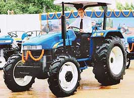 Managing Director and CEO New Holland Tractors India Mario Gasparri  poses with newly unveiled tractor in New Delhi on Friday.