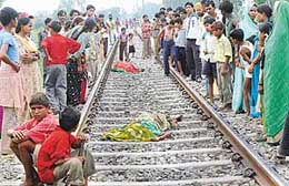 Onlookers gather around the railway track in Mansa Devi Complex, Panchkula, where Prem Wati and her son Ajay were crushed under a train on Friday.