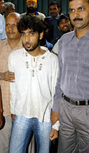 Policemen escort Asim Wasim (centre), a Pakistani spy, for a court appearance in New Delhi on Friday.