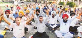 Teachers stage a dharna in front of the DEOs office in the mini secretariat in Ludhiana on Friday