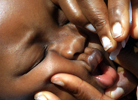 A baby receives polio vaccine in Lagos, Nigeria, on Friday
