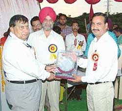 Mr C.M. Behl, MD, Rayat Educational and Research Trust, presents trophy to the winners of the PTU Inter-College Hockey Tournament at the Rayat Institute of Engineering & Information Technology in Mohali on Friday