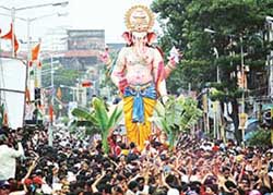 Devotees carry a huge idol of `Ganesh' for immersion in Mumbai on the last day of the Ganesh Festival on Saturday. 