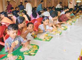 People enjoy a feast as part of Onam celebrations by the Kerala Kalavedi in Ludhiana