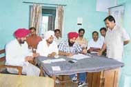 Officials on duty at a polling station in Amloh on Sunday