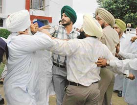 Workers of the SAD and the Congress clash in front of the polling station at Dehradoon Public School in Patiala on Sunday during MC poll