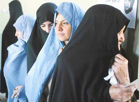 Afghan women wait in queue to vote in the parliamentary elections in Herat