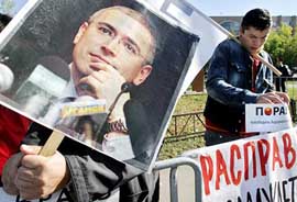 A supporter of the imprisoned former head of the Yukos oil company, Mikhail Khodorkovsky, holds his portrait during a protest outside Moscow City court on Monday. Khodorkovsky and his former business associate, Platon Lebedev, are appealing against their May, 2005, convictions and nine-year jail sentences in a trial that was widely condemned as rigged against the politically ambitious Khodorkovsky, once Russia's richest man.