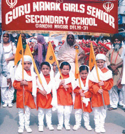 Schoolchildren participating in a Nagar Kirtan at Gandhi Nagar in the Capital.