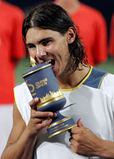 Spains Rafael Nadal with the China Open trophy after defeating Argentinas Guillermo Coria 5-7, 6-1, 6-2 in the final in Beijing on Sunday