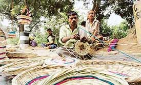 Weavers from Moradabad make baskets on the Chandigarh road in Ludhiana. 