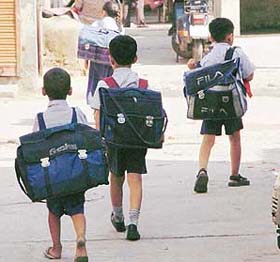 These kids have to do a man’s job carrying heavy bags to school