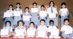 Students display merit certificates after winning a story-telling competition held at Sanatan Vidya Mandir School in Ludhiana