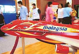 Visitors walk past a model of a Boeing 747 aircraft from Malaysian Airlines during the Malaysia Airlines Travel Fair Indonesia
