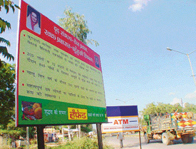 A hoarding displays welfare policies of the Haryana government, on the Panchkula-Shimla National Highway