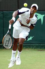 Prakash Amritraj serves against Jonas Bjorkman of Sweden in the first singles of the Davis Cup World Group playoff tie in New Delhi
