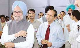 Prime Minister Manmohan Singh shares a light moment with Prof K. N. Pathak, Vice-Chancellor, Panjab University, at the 125th anniversary celebrations of The Tribune at Bhargava Auditorium, PGI, Chandigarh, on Saturday.