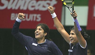 Uberoi sisters Shikha and Neha celebrate their semifinal victory over Hungary's Melinda Czink and Ukraine's Yuliana Fedak 