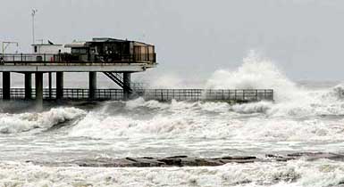Waves kicked up by Hurricane Rita crash over the lower fishing pier at the Flagship Hotel in Galveston, Texas, on Friday