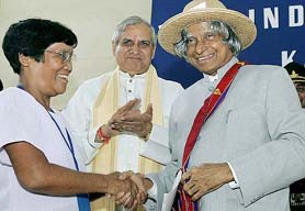 President A.P.J. Abdul Kalam wears a traditional Mizo cap during a visit to Sairang village in Mizoram on Sunday as Governor A.R. Kohli looks on. 