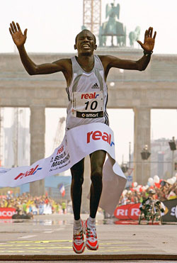 Kenya's Philip Manyim celebrates as he crosses the finish line to win the Berlin marathon in front of the Brandenburg Gate in Berlin on Sunday