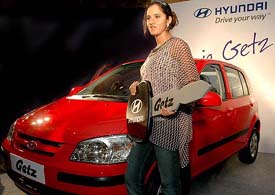 Indian tennis sensation Sania Mirza poses with a Hyundai Getz in New Delhi on Monday. 